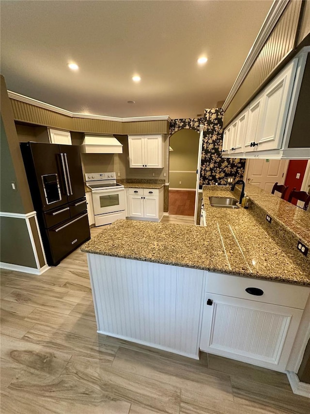 kitchen with kitchen peninsula, white cabinetry, white electric range, and black fridge with ice dispenser