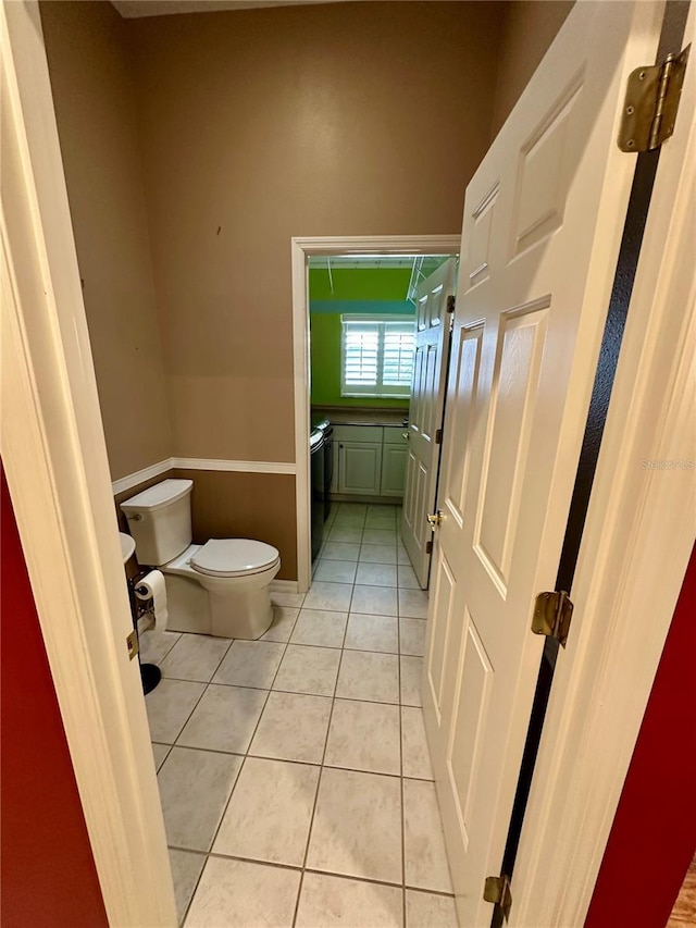 bathroom featuring toilet and tile patterned floors