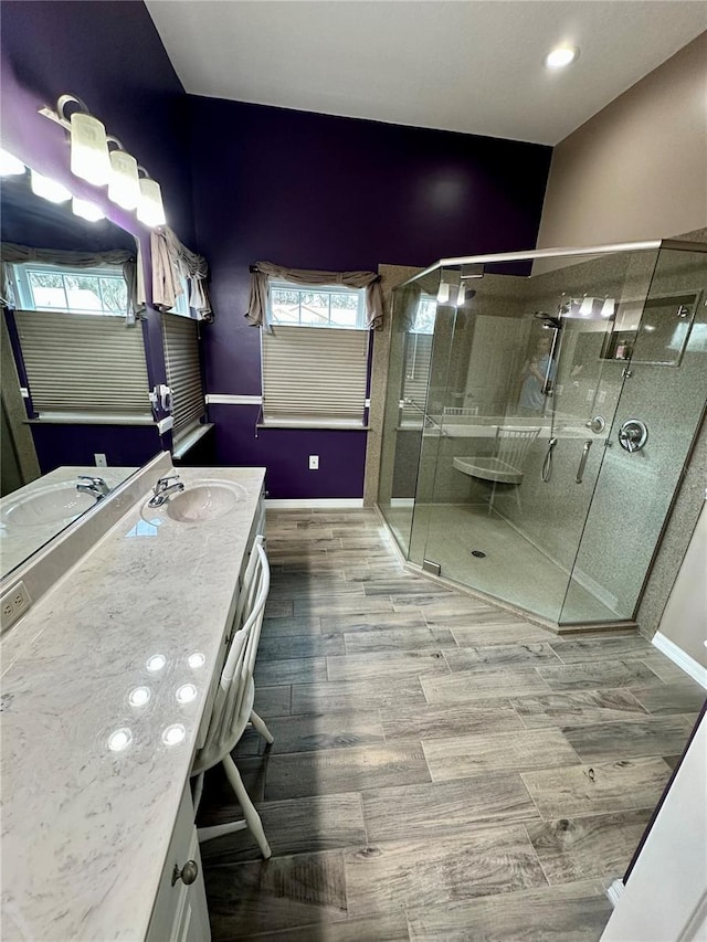 bathroom featuring wood-type flooring, vanity, and walk in shower