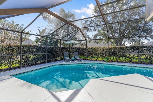 view of swimming pool with a patio area and glass enclosure