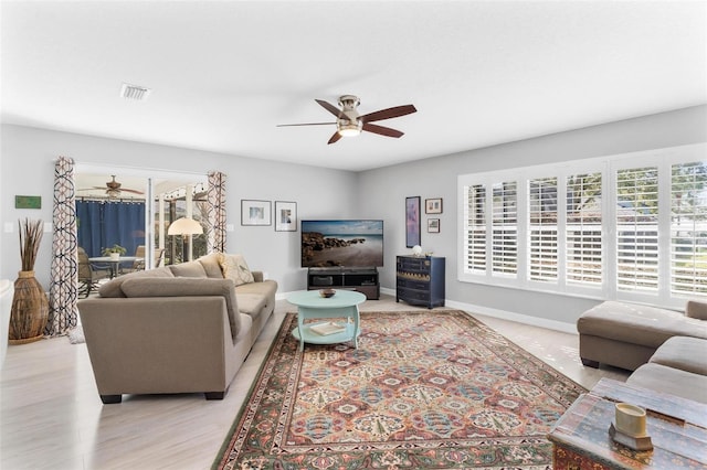 living room featuring ceiling fan and light hardwood / wood-style flooring