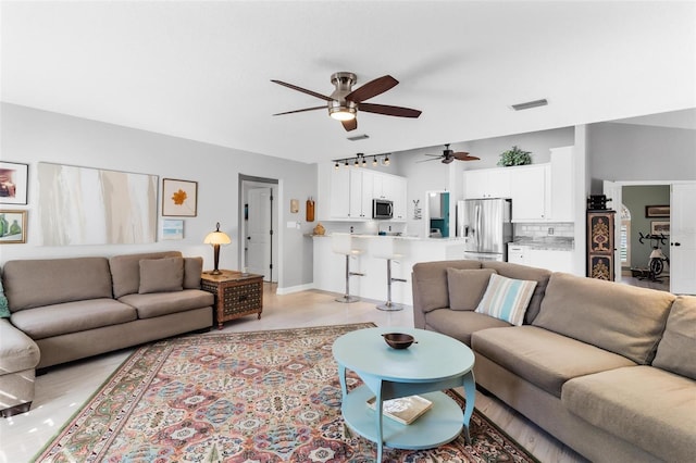 tiled living room featuring ceiling fan