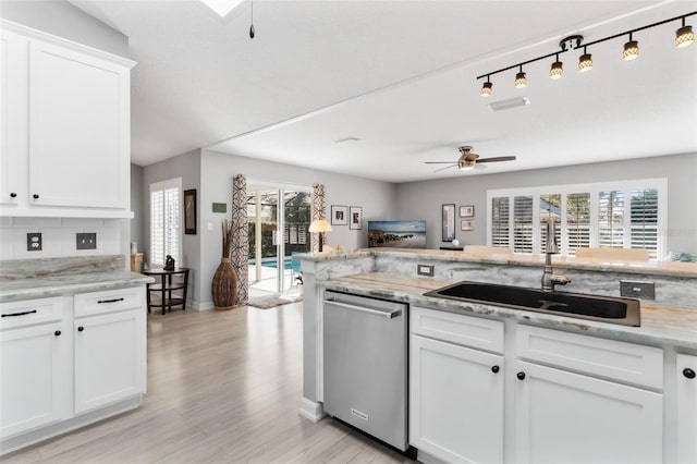 kitchen featuring white cabinetry, ceiling fan, sink, light hardwood / wood-style flooring, and stainless steel dishwasher