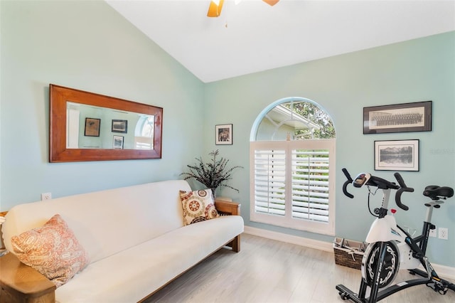 exercise area with hardwood / wood-style floors, vaulted ceiling, and ceiling fan