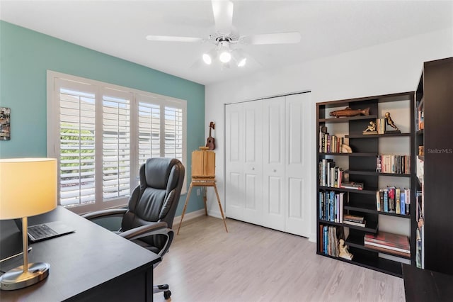 office space with light hardwood / wood-style flooring and ceiling fan