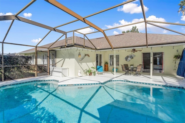 view of swimming pool with a lanai, ceiling fan, and a patio