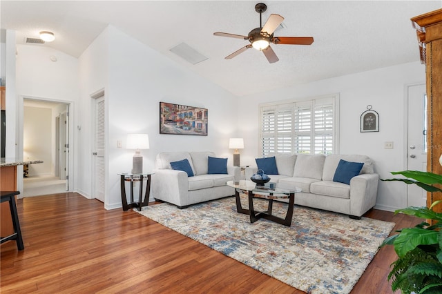 living room with high vaulted ceiling, ceiling fan, and dark hardwood / wood-style floors