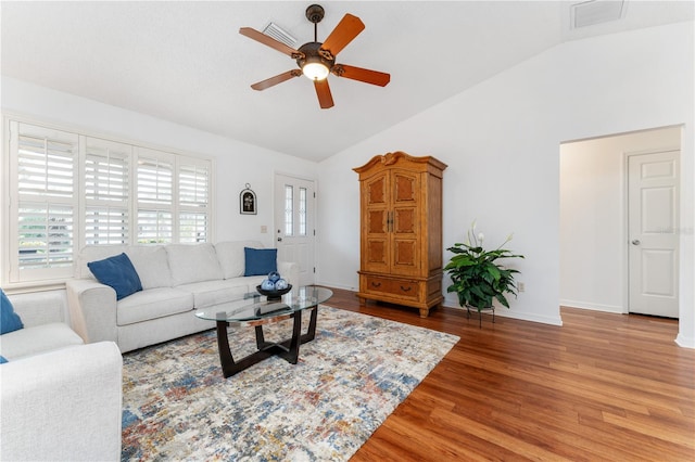 living room featuring hardwood / wood-style floors, ceiling fan, and vaulted ceiling