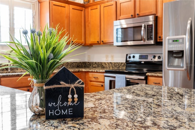 kitchen with stainless steel appliances and light stone counters