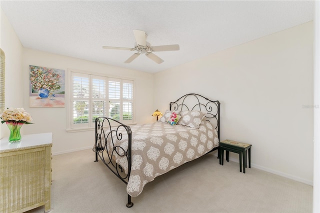 bedroom with light colored carpet and ceiling fan