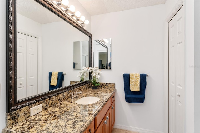 bathroom featuring vanity and a textured ceiling