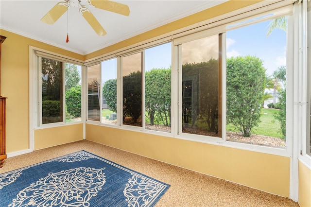 sunroom with a wealth of natural light and ceiling fan