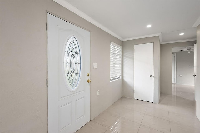 foyer featuring ornamental molding and ceiling fan