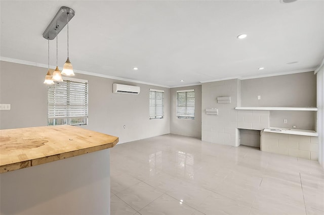 unfurnished living room featuring crown molding and a wall mounted AC