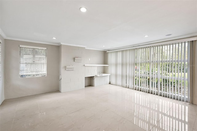 unfurnished living room featuring ornamental molding and light tile patterned floors