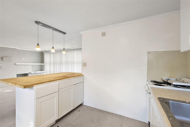 kitchen featuring butcher block counters, stainless steel range, crown molding, decorative light fixtures, and white cabinets