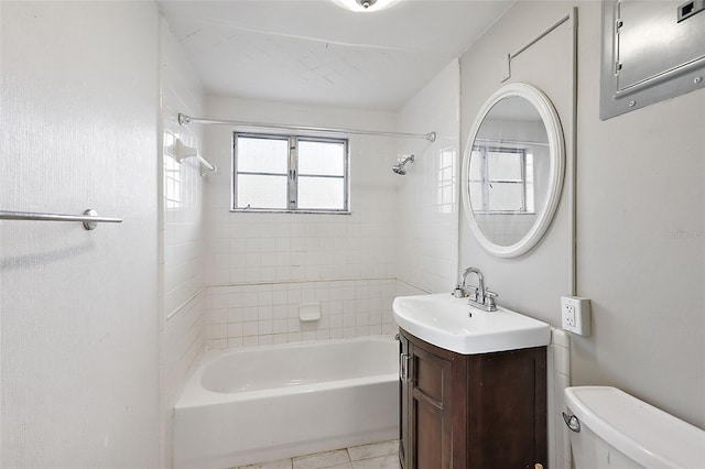 full bathroom with vanity, toilet, tiled shower / bath combo, and tile patterned flooring