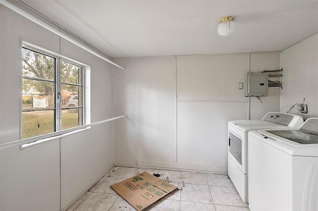 laundry area featuring independent washer and dryer, electric panel, and light tile patterned floors