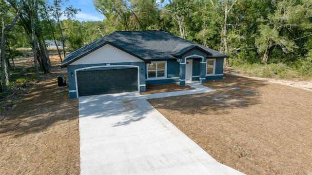 view of front of home with a garage and central AC unit