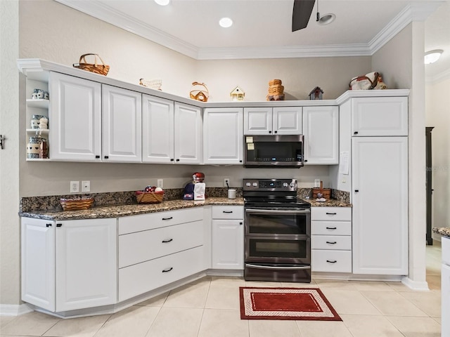 kitchen featuring stainless steel appliances, white cabinets, dark stone countertops, crown molding, and light tile patterned flooring