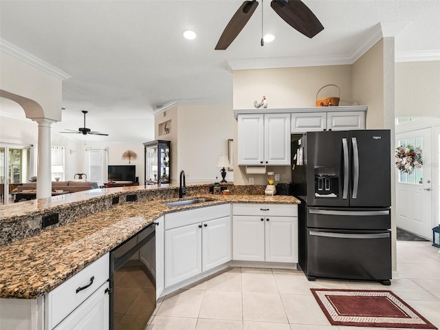 kitchen featuring dark stone counters, sink, white cabinets, and refrigerator with ice dispenser