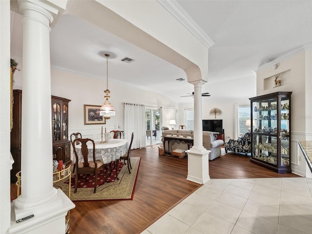 dining area featuring ceiling fan, light wood-type flooring, and ornamental molding