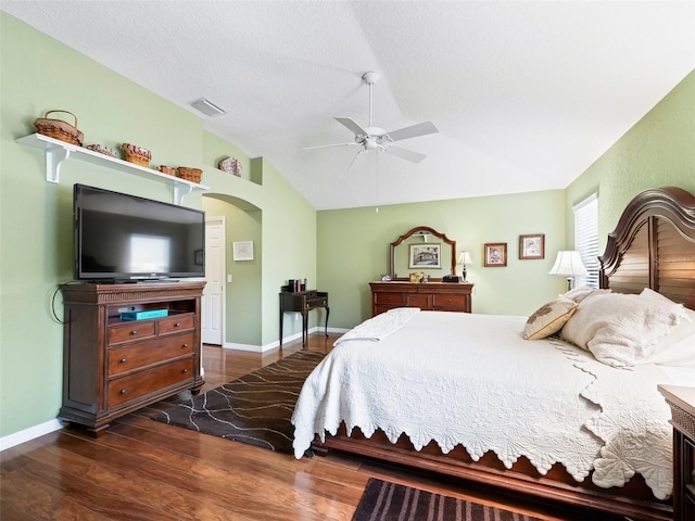 bedroom featuring vaulted ceiling, ceiling fan, a textured ceiling, and dark hardwood / wood-style floors