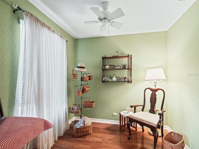 living area featuring ceiling fan and wood-type flooring