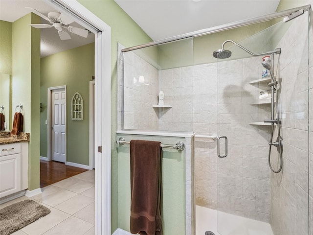 bathroom with tile patterned flooring, vanity, ceiling fan, and an enclosed shower