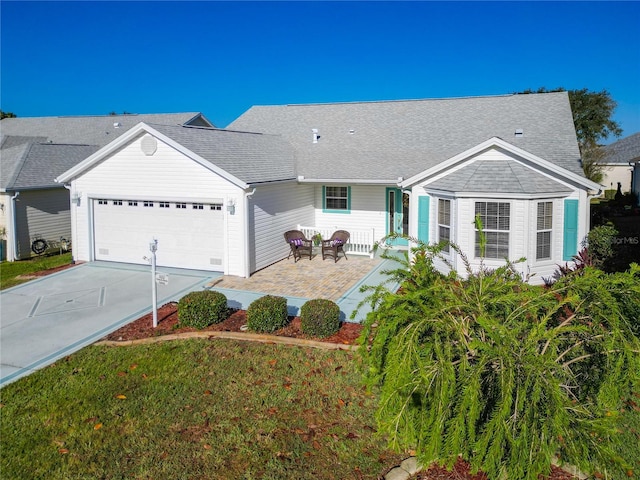 ranch-style home with a garage and a front lawn