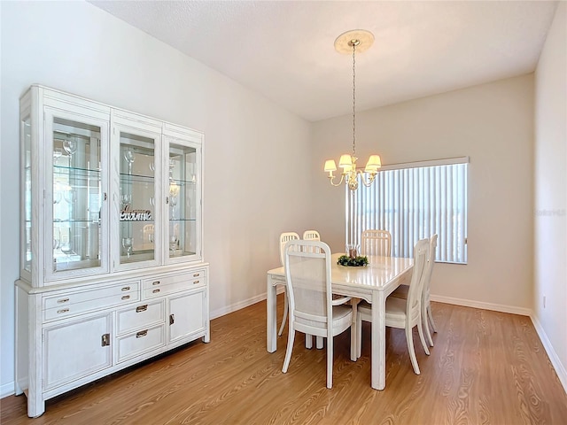 dining area featuring a chandelier, plenty of natural light, and light hardwood / wood-style flooring