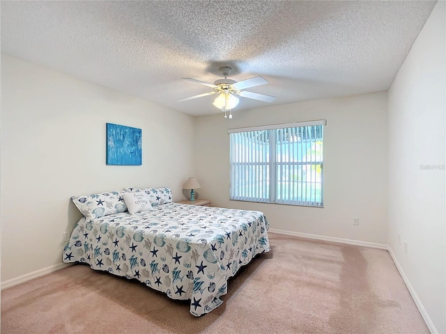 carpeted bedroom featuring a textured ceiling and ceiling fan