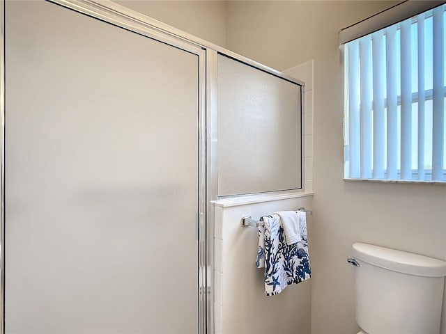 bathroom with walk in shower and toilet