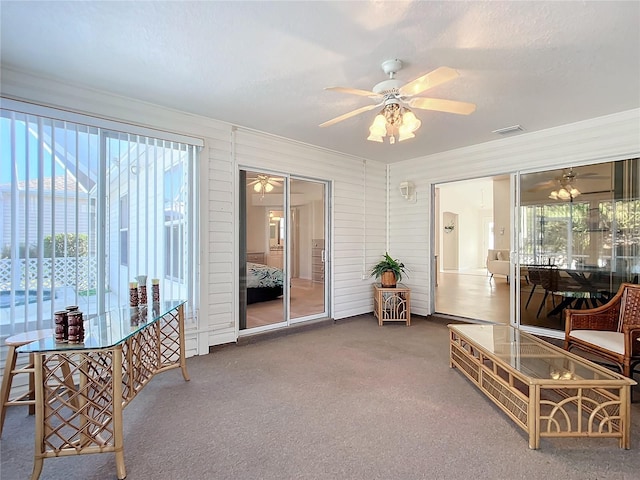 sunroom with a wealth of natural light and ceiling fan