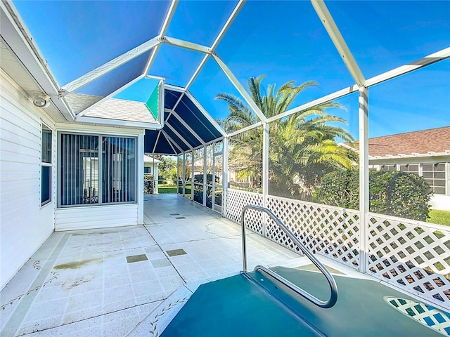 view of patio / terrace featuring glass enclosure