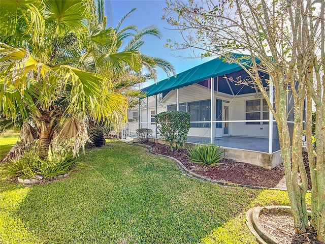 view of yard featuring a sunroom and a patio area