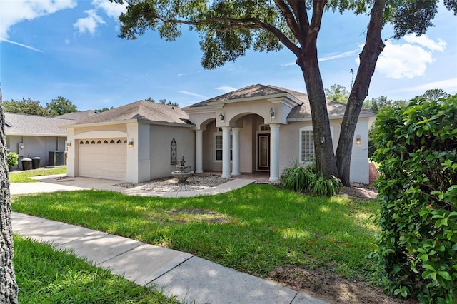 mediterranean / spanish-style house with a front lawn and a garage