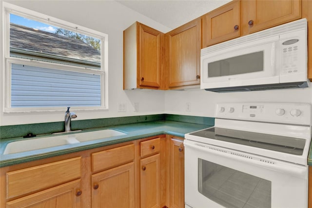 kitchen featuring white appliances and sink