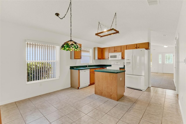 kitchen with pendant lighting, a center island, white appliances, and plenty of natural light