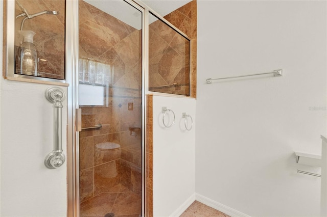 bathroom featuring a shower with shower door