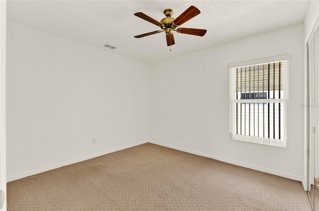 unfurnished room with carpet, a textured ceiling, and ceiling fan