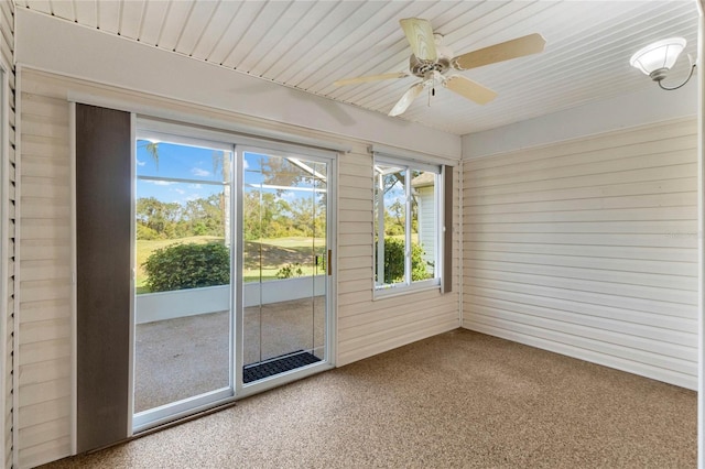 unfurnished sunroom featuring ceiling fan