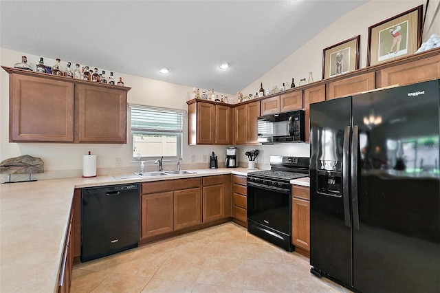 kitchen featuring lofted ceiling, light tile patterned flooring, sink, and black appliances