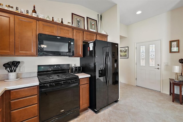 kitchen featuring black appliances and light tile patterned floors