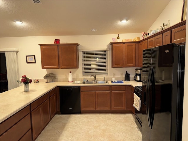 kitchen with sink, a textured ceiling, black appliances, and kitchen peninsula