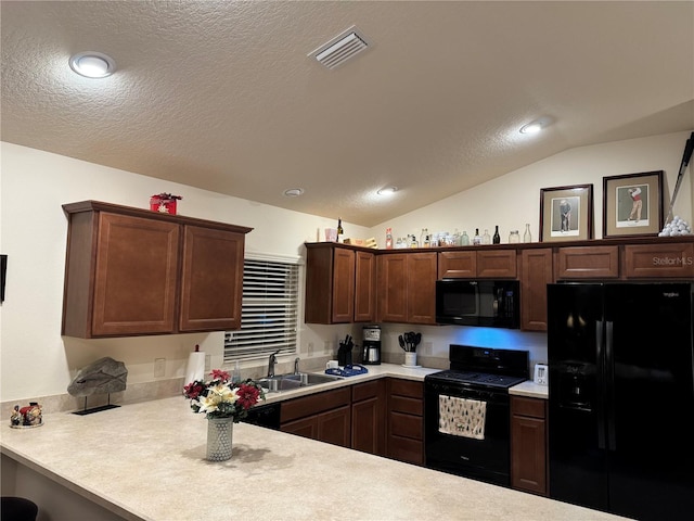 kitchen featuring a textured ceiling, black appliances, sink, kitchen peninsula, and vaulted ceiling