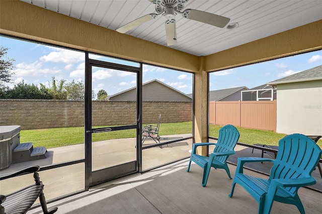 sunroom / solarium featuring ceiling fan