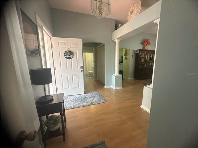 entrance foyer with hardwood / wood-style floors and ornate columns