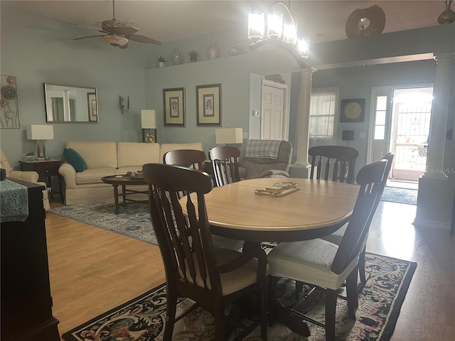 dining room featuring ornate columns, hardwood / wood-style flooring, and ceiling fan