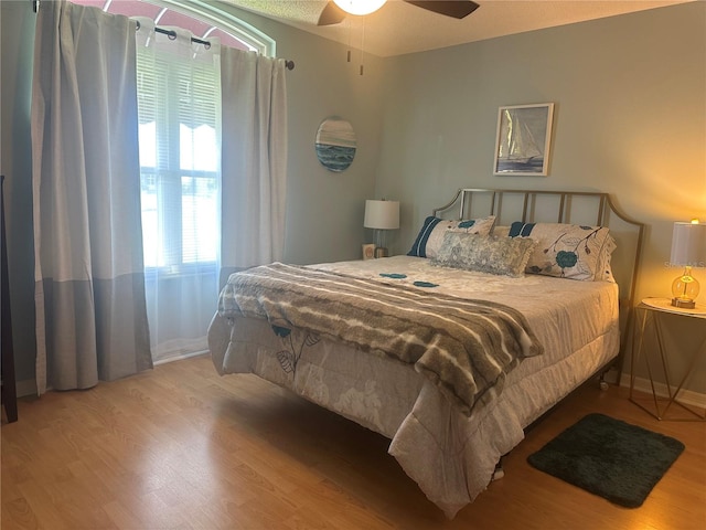 bedroom featuring wood-type flooring and ceiling fan